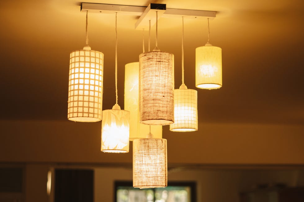 closeup shot of decorative lights on the roof of the home, ceiling lamp lighting decoration in a building interior. decorative electric lamps hanging on ceiling of the home. real estate background.