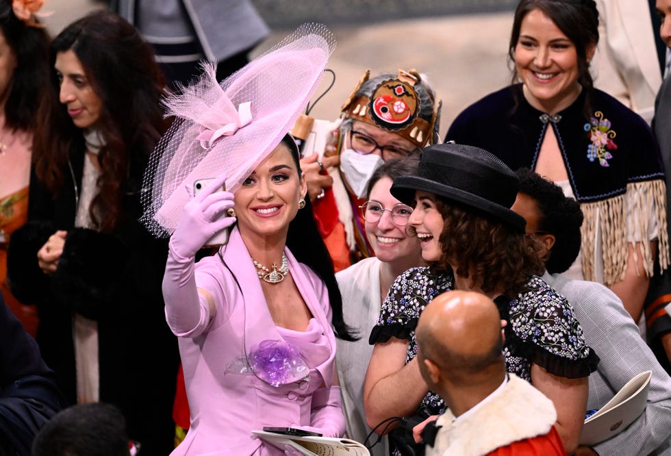 london, england may 06 katy perry takes selfies with guests during the coronation of king charles iii and queen camilla on may 06, 2023 in london, england the coronation of charles iii and his wife, camilla, as king and queen of the united kingdom of great britain and northern ireland, and the other commonwealth realms takes place at westminster abbey today charles acceded to the throne on 8 september 2022, upon the death of his mother, elizabeth ii photo by gareth cattermolegetty images