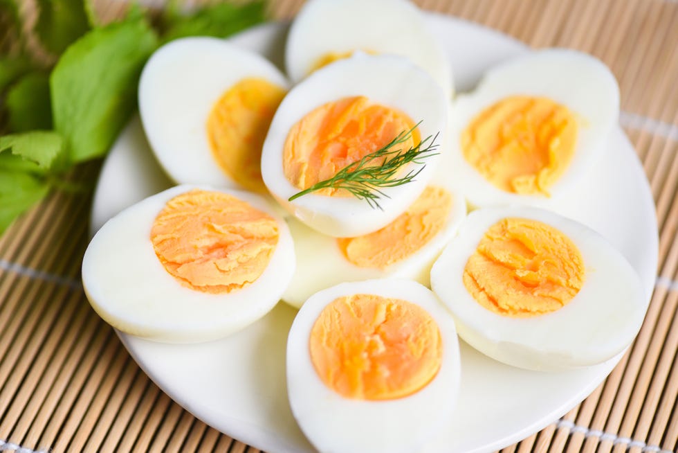hard boiled eggs sliced in half on a white plate