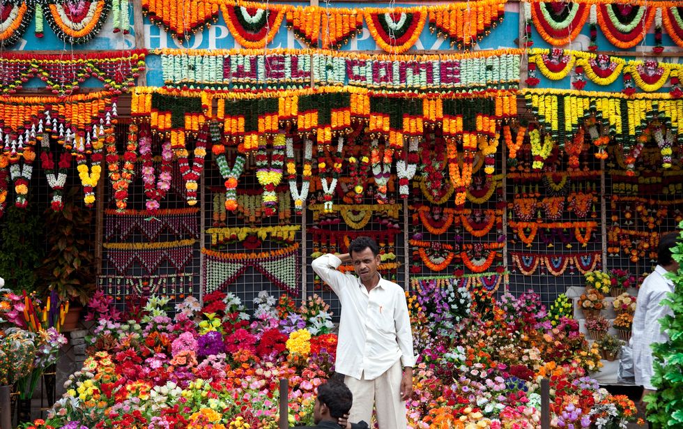 Man tending flower stall on Mutton Street at Chor Bazaar.