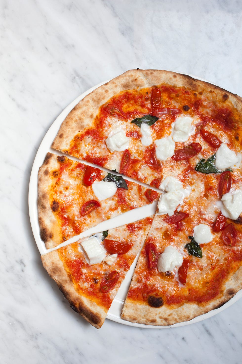 Whole pizza with buffalo mozzerella, tomato, basil