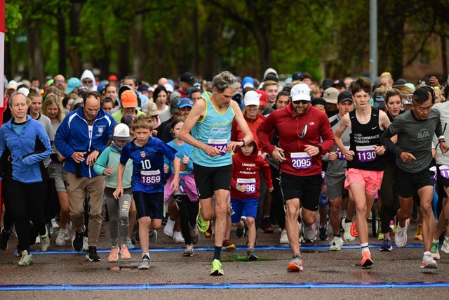 a group of runners on the starting line of a road race