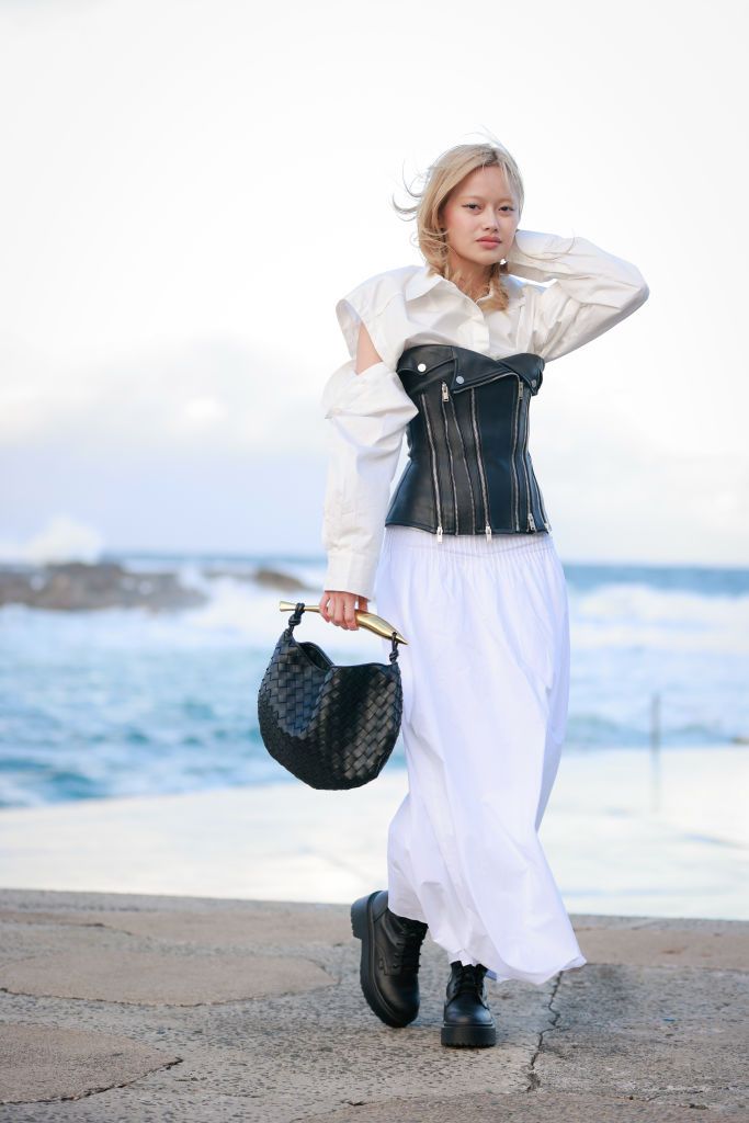 sydney, australia may 17 a guest wearing white shirt, dion lee leather corset, joslin white maxi skirt and bottega veneta black bag at afterpay australian fashion week 2023 at carriageworks on may 17, 2023 in sydney, australia photo by hanna lassengetty images