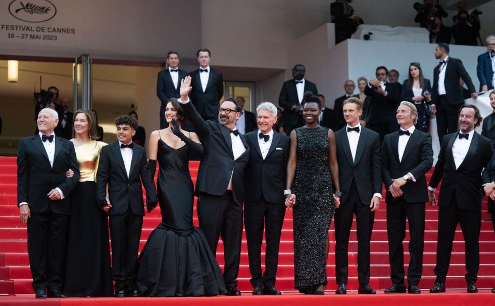 cannes, france may 18 l r producer frank marshall, producer kathleen kennedy, ethann isodoree, phoebe waller bridge, director james mangold, harrison ford, shaunette renée wilson, boyd holbrook, mads mikkelsen and producer simon emanuel attend the indiana jones and the dial of destiny red carpet during the 76th annual cannes film festival at palais des festivals on may 18, 2023 in cannes, france photo by samir husseinwireimage