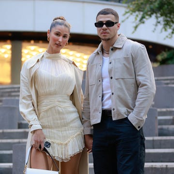 sydney, australia may 19 a guest wearing shona joy yellow dress and trench coat, a guest r wearing grey suede jacket and black pants at afterpay australian fashion week 2023 at carriageworks on may 19, 2023 in sydney, australia photo by hanna lassengetty images