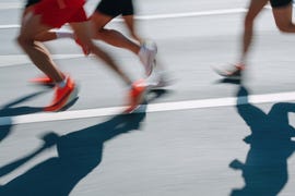 low section people running fast in the city, defocused sports background