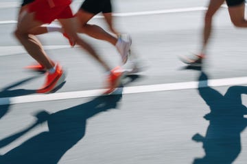 low section people running fast in the city, defocused sports background