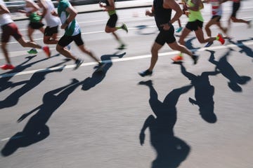 abstract sports background. unknown people running marathon distance. real life, side view, ambient day light, copy space, blurred motion