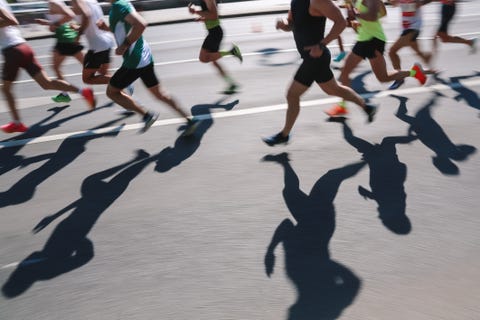 abstract sports background. unknown people running marathon distance. real life, side view, ambient day light, copy space, blurred motion