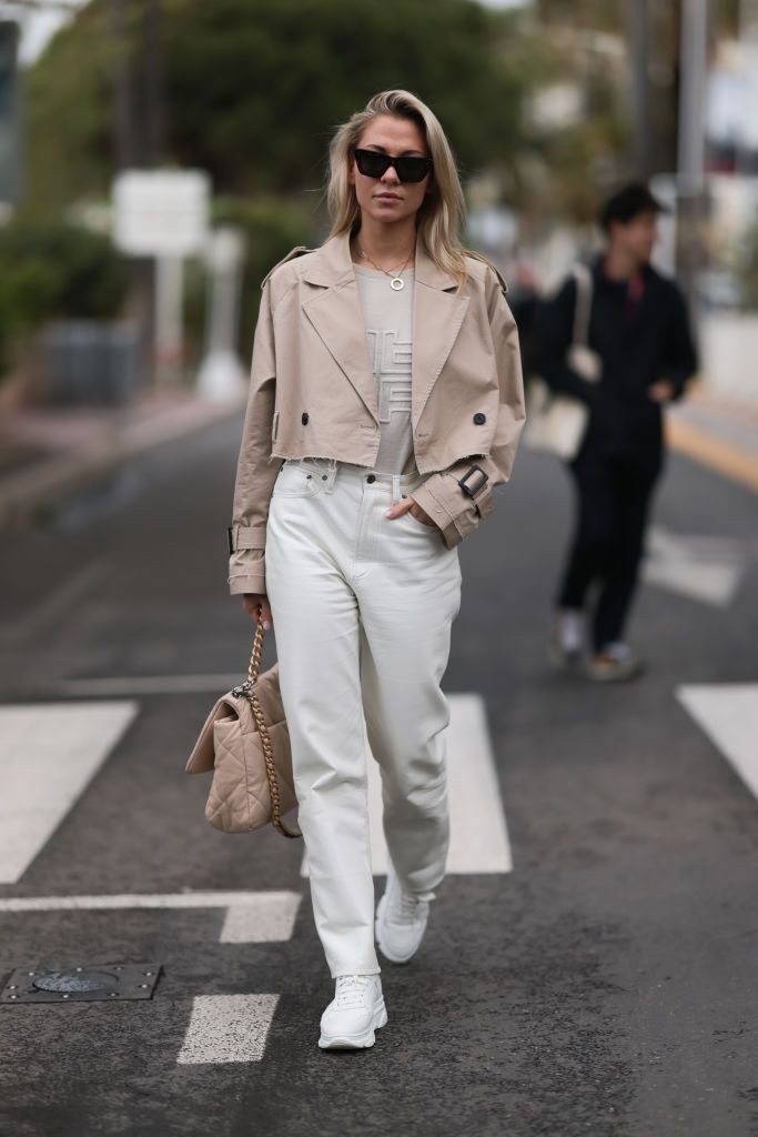 cannes, france may 21 valentina pahde seen wearing chanel beige bag, cartier love yellowgold necklace, white jeans shorts, riani beige sweater, cropped beige trench jacket, black sunglasses, copenhagen studios white sneakers during the 76th cannes film festival on may 21, 2023 in cannes, france photo by jeremy moellergetty images
