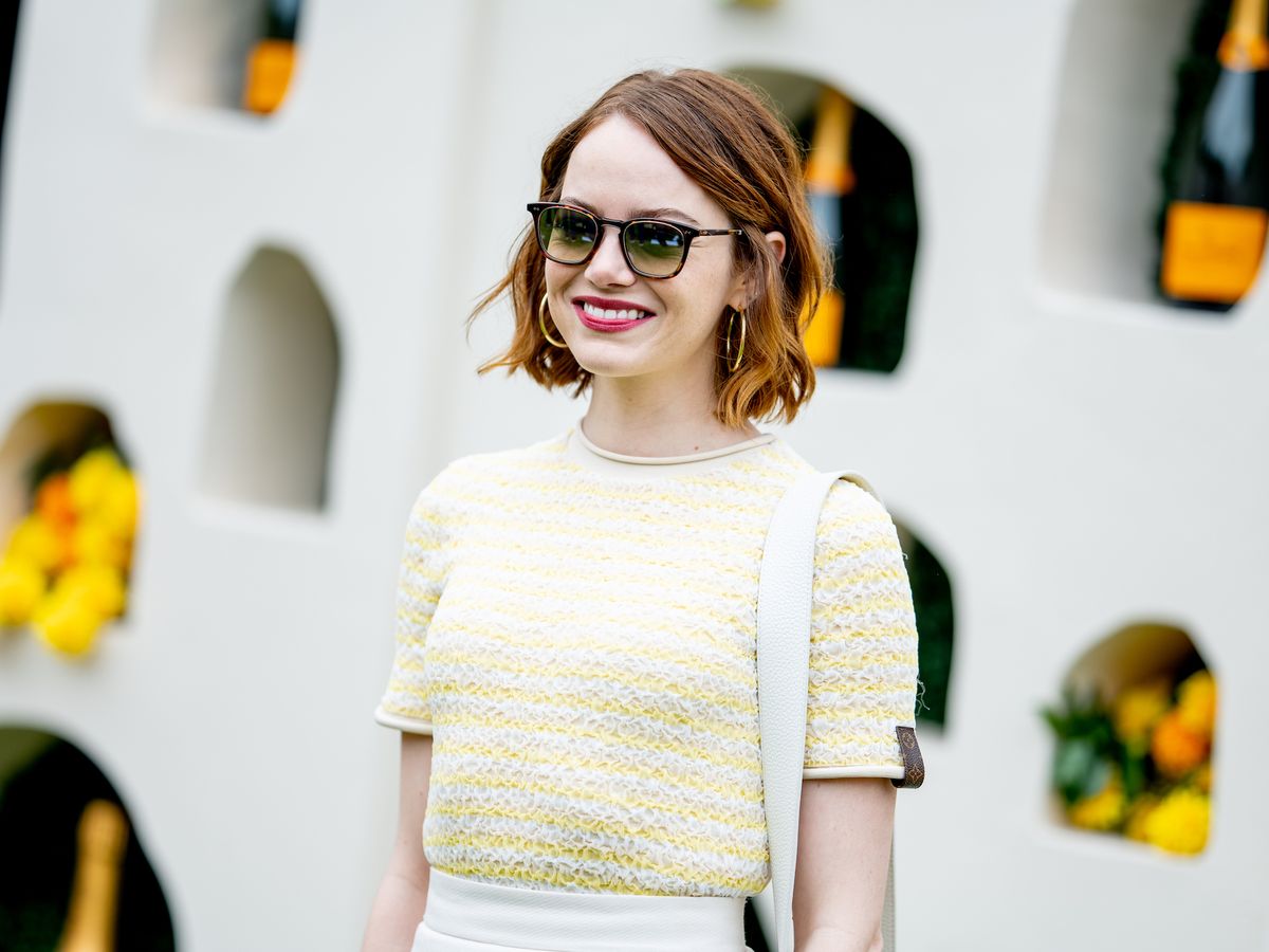 Emma Stone looks chic in plunging ivory blazer in Paris