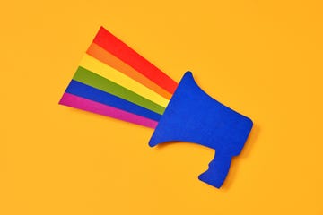 directly above view of a blue paper cutout megaphone with the lgtbi flag coming out of it. concept of fight for the rights of homosexual people.