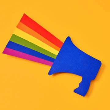 Megaphone with an LGTBI flag coming out of it on a yellow background directly above view of a blue paper cutout megaphone with the lgtbi flag coming out of it. concept of fight for the rights of homosexual people.