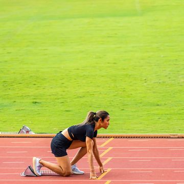 asian young sportswoman sprint on a running track outdoors on stadium attractive strong athlete girl runner exercise and practicing workout speed running marathon on the race for olympics competition