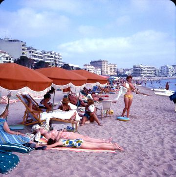 view of people, including sunbathers, on the beach near the hotel martinez, cannes, france, may 1962 photo by harold lloydgetty images