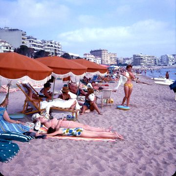 view of people, including sunbathers, on the beach near the hotel martinez, cannes, france, may 1962 photo by harold lloydgetty images