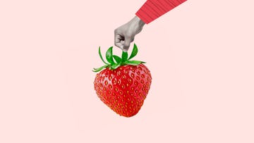 contemporary art collage with hand holding strawberry. the concept of fresh and raw food. modern design. copy space.