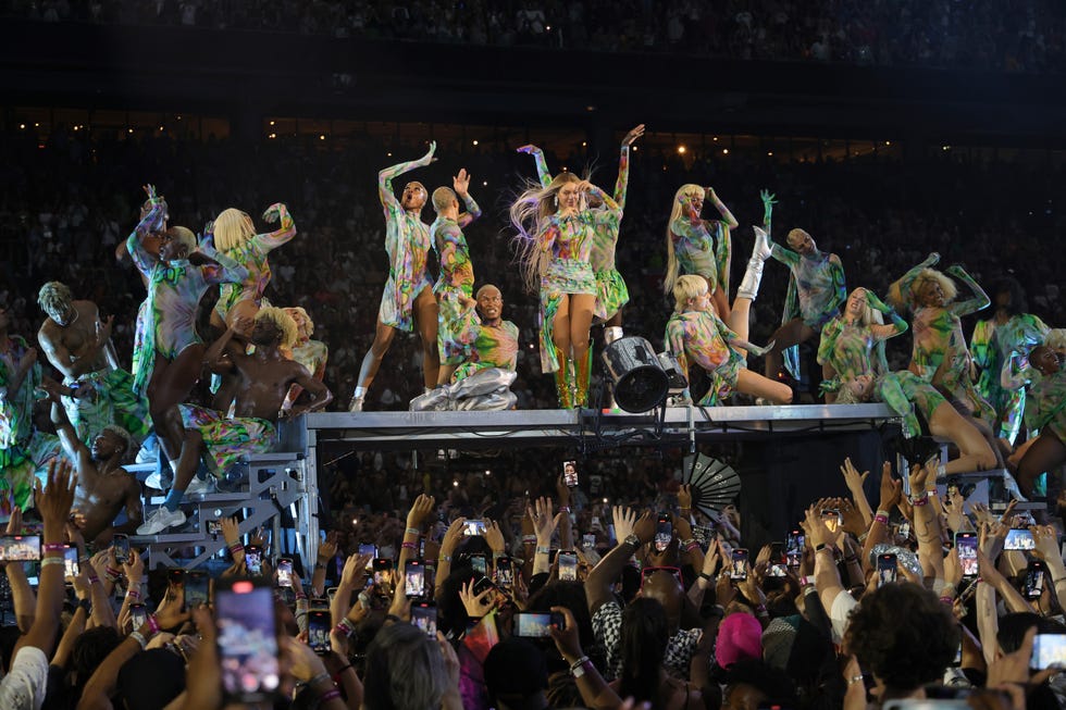 beyonce performing with dancers in colorful outfits