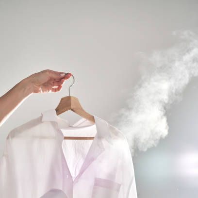 clothes steamer vs iron image of steaming a shirt