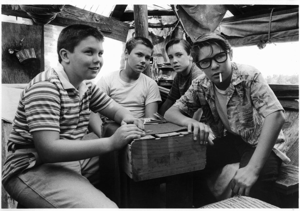 jerry o'connell, river phoenix, wil wheaton, and corey feldman are gathered around together in a scene from the film 'stand by me', 1986 photo by columbia picturesgetty images
