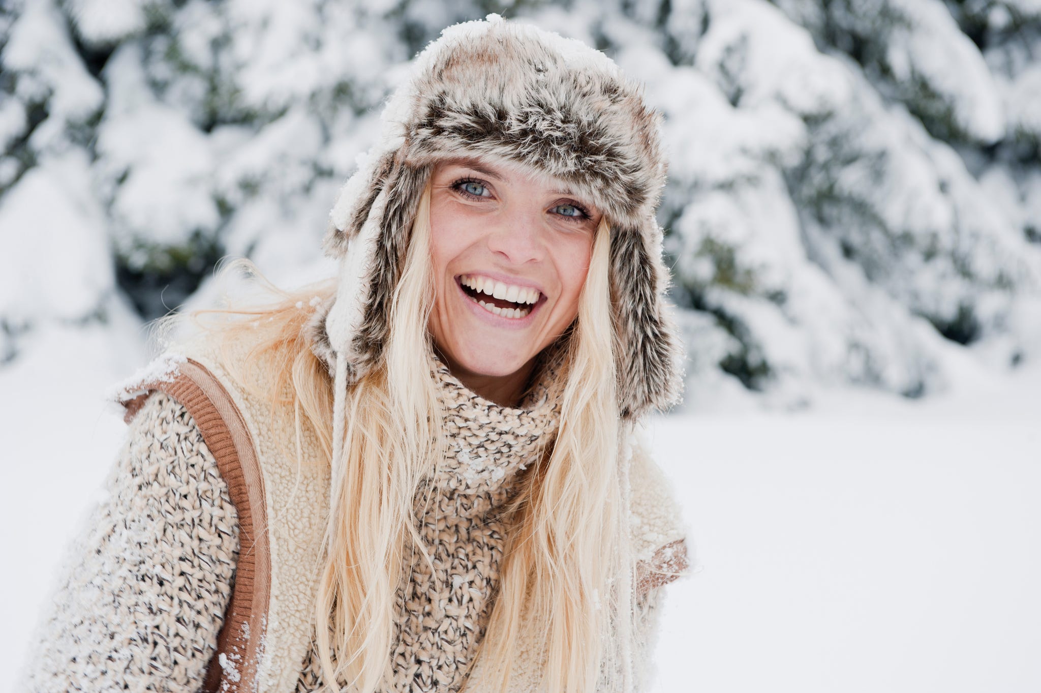 woman in snow wearing winter clothes