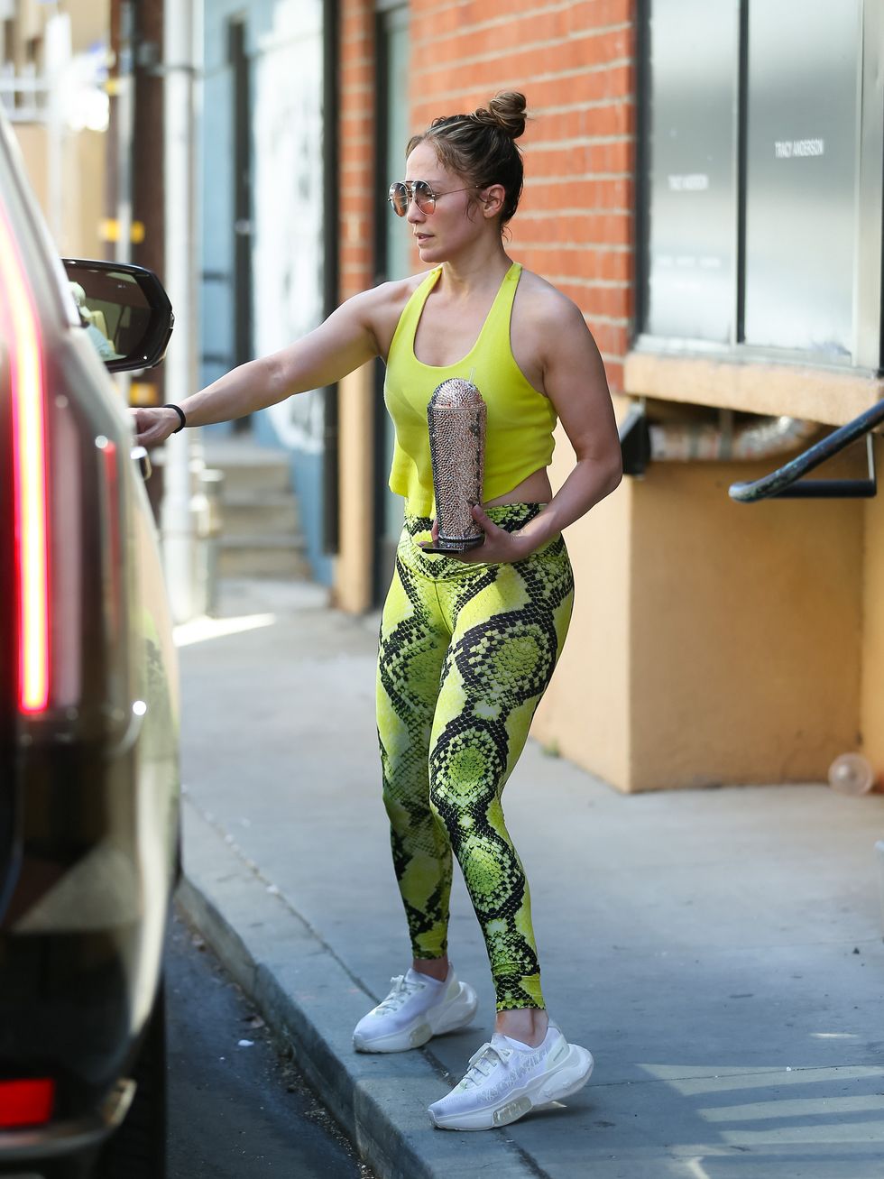 Who made Jennifer Lopez's black leggings, sunglasses, and white