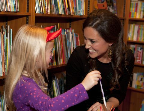 Pippa Middleton with a young girl at a children's party in 2012.​