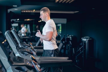 young man using the treadmill in the gym