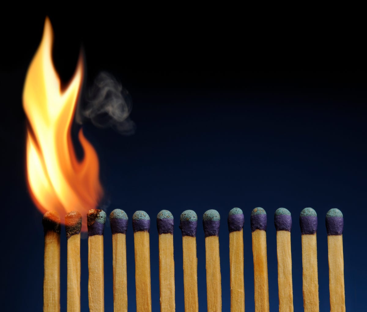 A lot of burnt matchsticks and one matchstick prevents following burning.  Concept of stop spreading coronavirus and stay at home Stock Photo