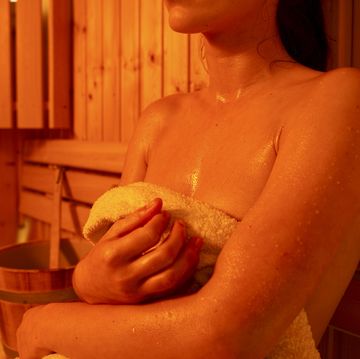 girl in sauna,, sweating,, visible water drops sweat