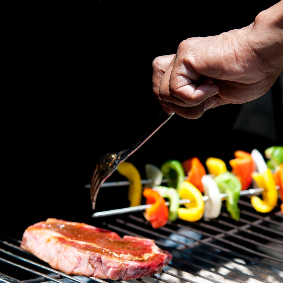 food on the grill   selective focus on the hand