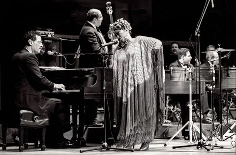 cuban american salsa performer celia cruz 1925   2003 and her band onstage during a jazz at lincoln center concert at alice tully hall, new york, new york, december 12, 1992 photo by jack vartoogiangetty images