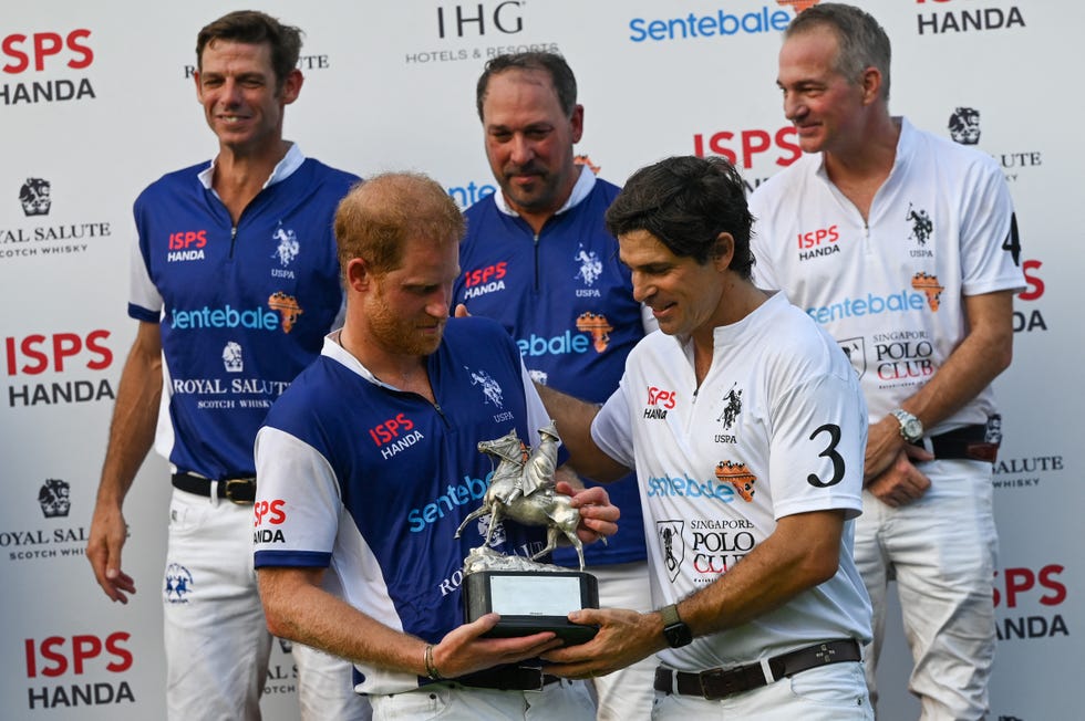 britains prince harry front l and argentine polo player nacho figueras front r receive a shared trophy after the sentebale isps handa polo cup in singapore on august 12, 2023 photo by roslan rahman afp photo by roslan rahmanafp via getty images