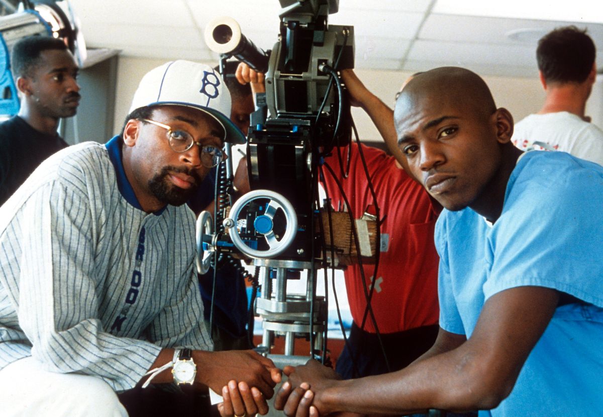 Director Spike Lee sitting with Mekhi Phifer in between scenes from the film 'Clockers', 1995.