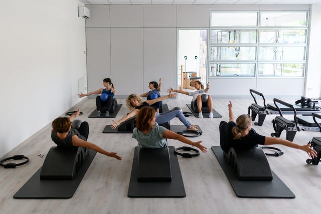 pilates studio gym exercises class on mat with pilates arc