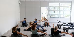 pilates studio gym exercises class on mat with pilates arc