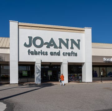 A Woman walking into the JOANN Fabrics and Crafts store in Sarasota, Florida, USA. sarasota, florida, usa january 11, 2022: a woman walking into the joann fabrics and crafts store in sarasota, florida, usa. jo ann is an american specialty retailer of crafts and fabrics.