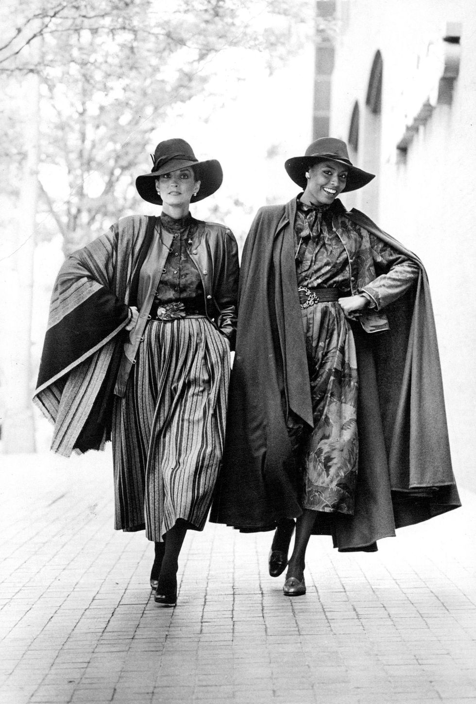 AUG 11 1981; Using fall's great wraps, Ungaro drapes outfits with shawl, left, long cape. At Montald