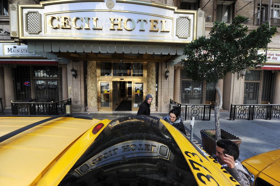 a taxi driver r waits as married british tourists mike and sabina baugh, both 27, put their bags in a taxi as they leave the cecil hotel to relocate to a different hotel, in los angeles california february 20, 2013 the body of 21 year old canadian tourist elisa lam was found in a water tank on the roof of the hotel three weeks after she went missing, police said the corpse was found february 19 after hotel guests complained of low water pressure  afp photorobyn beck        photo credit should read robyn beckafp via getty images