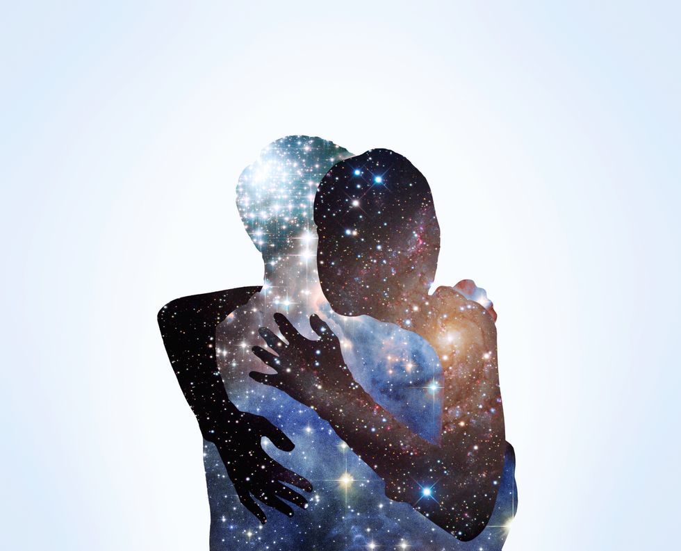 the shape of a couple hugging with stars