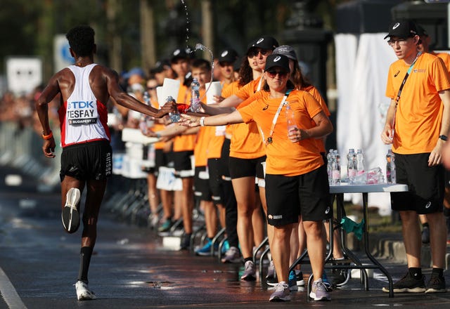 budapest, hungary august 27 volunteers hand water bottles to athletes in the mens marathon during day nine of the world athletics championships budapest 2023 on august 27, 2023 in budapest, hungary photo by michael steelegetty images