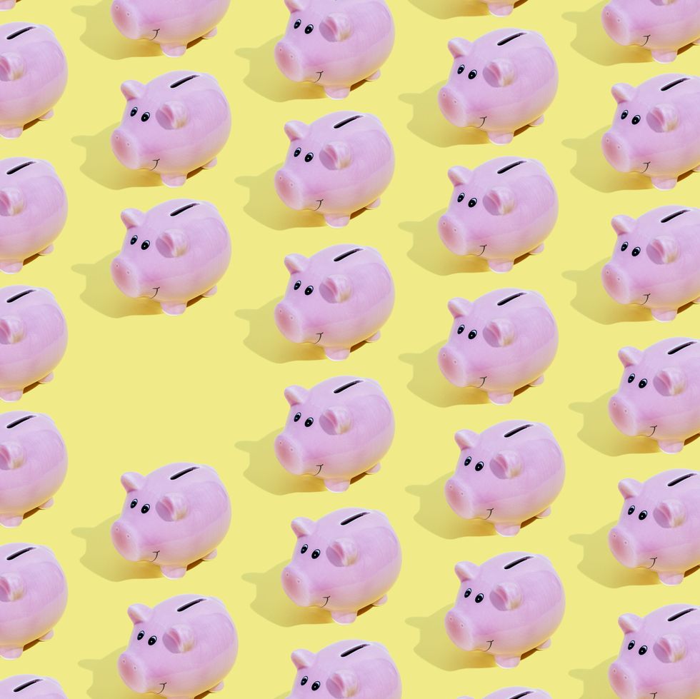 elevated view of some piggy banks on yellow background