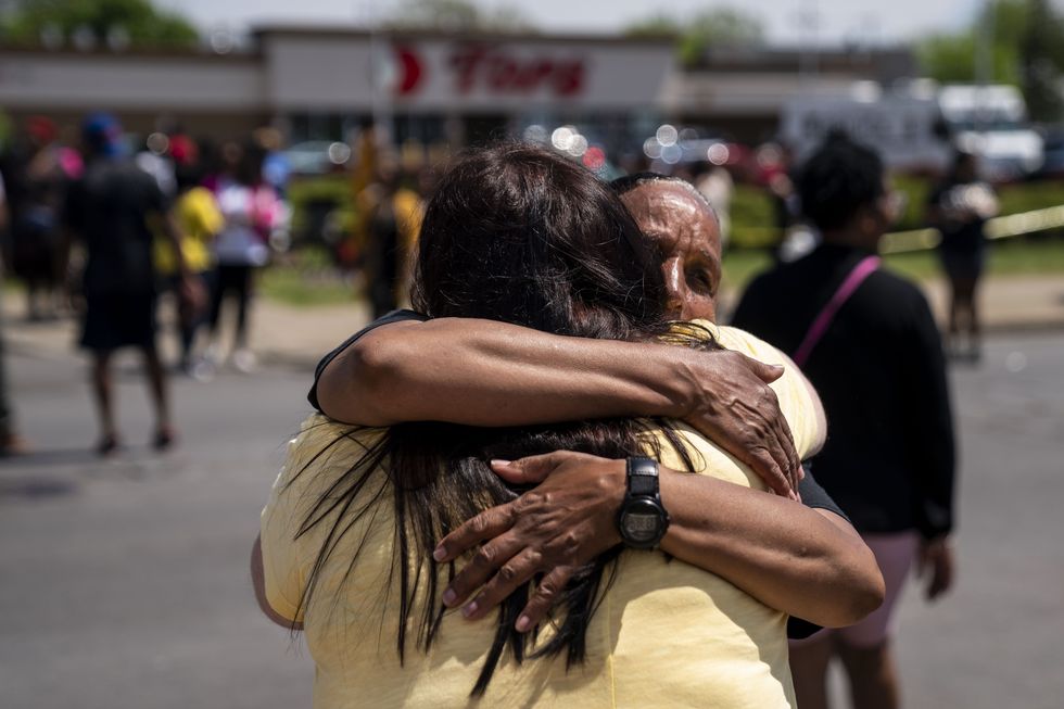 buffalo, ny   may 15 jeanne legall, of buffalo, hugs another visitor who came to pay their respects at tops friendly market at jefferson avenue and riley street on sunday, may 15, 2022 in buffalo, ny the fatal shooting of 10 people at a grocery store in a historically black neighborhood of buffalo by a young white gunman is being investigated as a hate crime and an act of racially motivated violent extremism, according to federal officials kent nishimura  los angeles times via getty images
