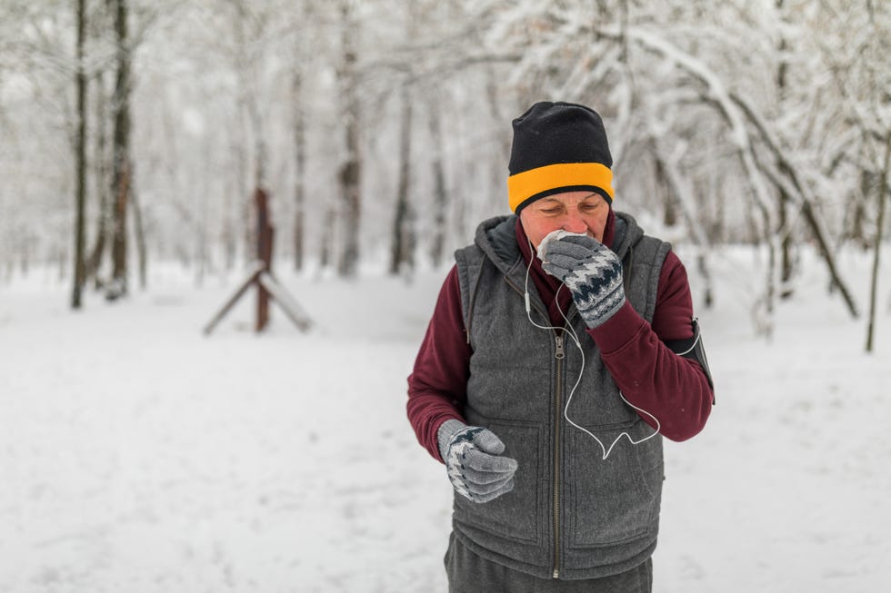 senior man jogging in snow