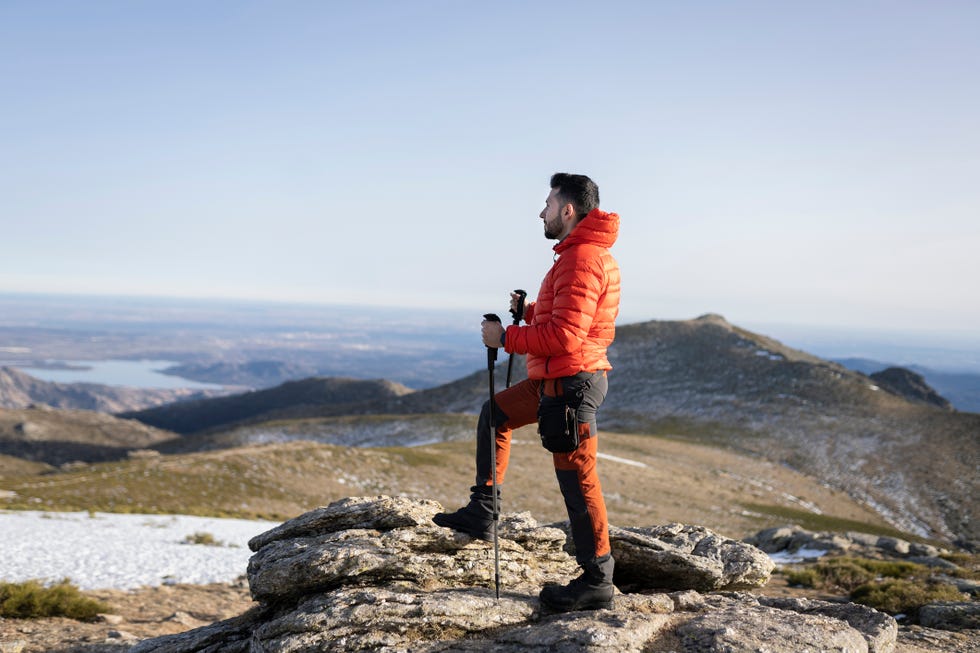 young man with red warm clothes, trekking mountain   travel concept