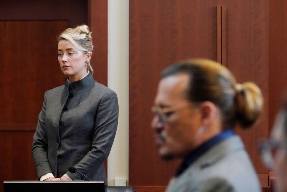 actors amber heard and johnny depp watch as the jury leave the courtroom for a lunch break at the fairfax county circuit courthouse in fairfax, virginia, on may 16, 2022   actor johnny depp sued his ex wife amber heard for libel in fairfax county circuit court after she wrote an op ed piece in the washington post in 2018 referring to herself as a public figure representing domestic abuse photo by steve helber  pool  afp photo by steve helberpoolafp via getty images