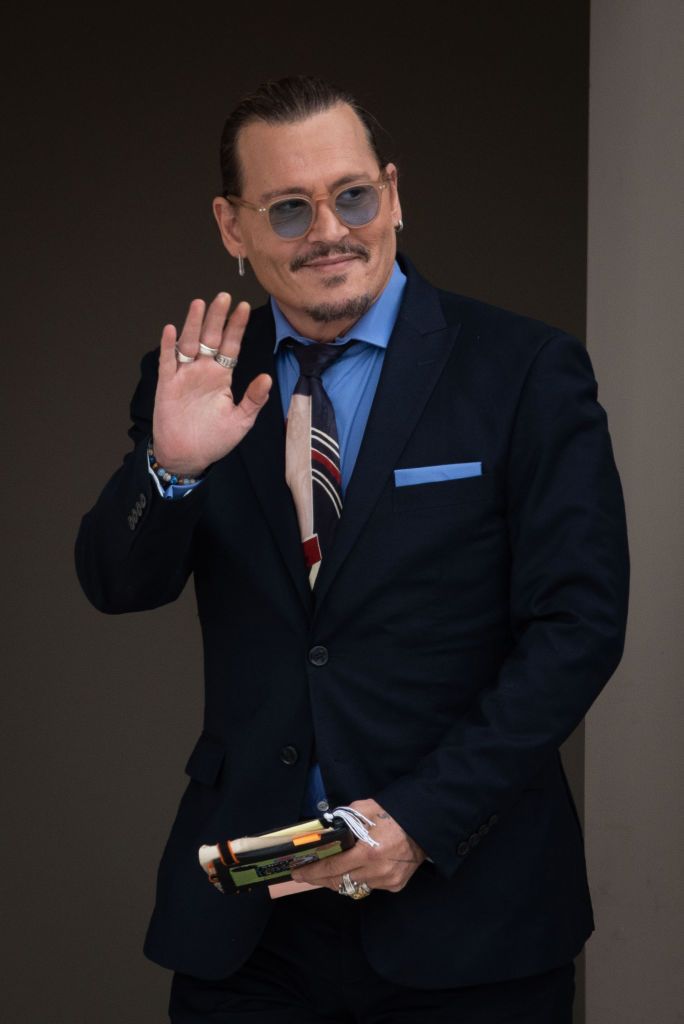 fairfax, va   may 5 ny  nj newspapers out johnny depp waves to his fans during the afternoon recess outside court during the johnny depp and amber heard civil trial at fairfax county circuit court on may 5, 2022 in fairfax, virginia depp is seeking $50 million in alleged damages to his career over an op ed heard wrote in the washington post in 2018photo by cliff owenconsolidated news picturesgetty images