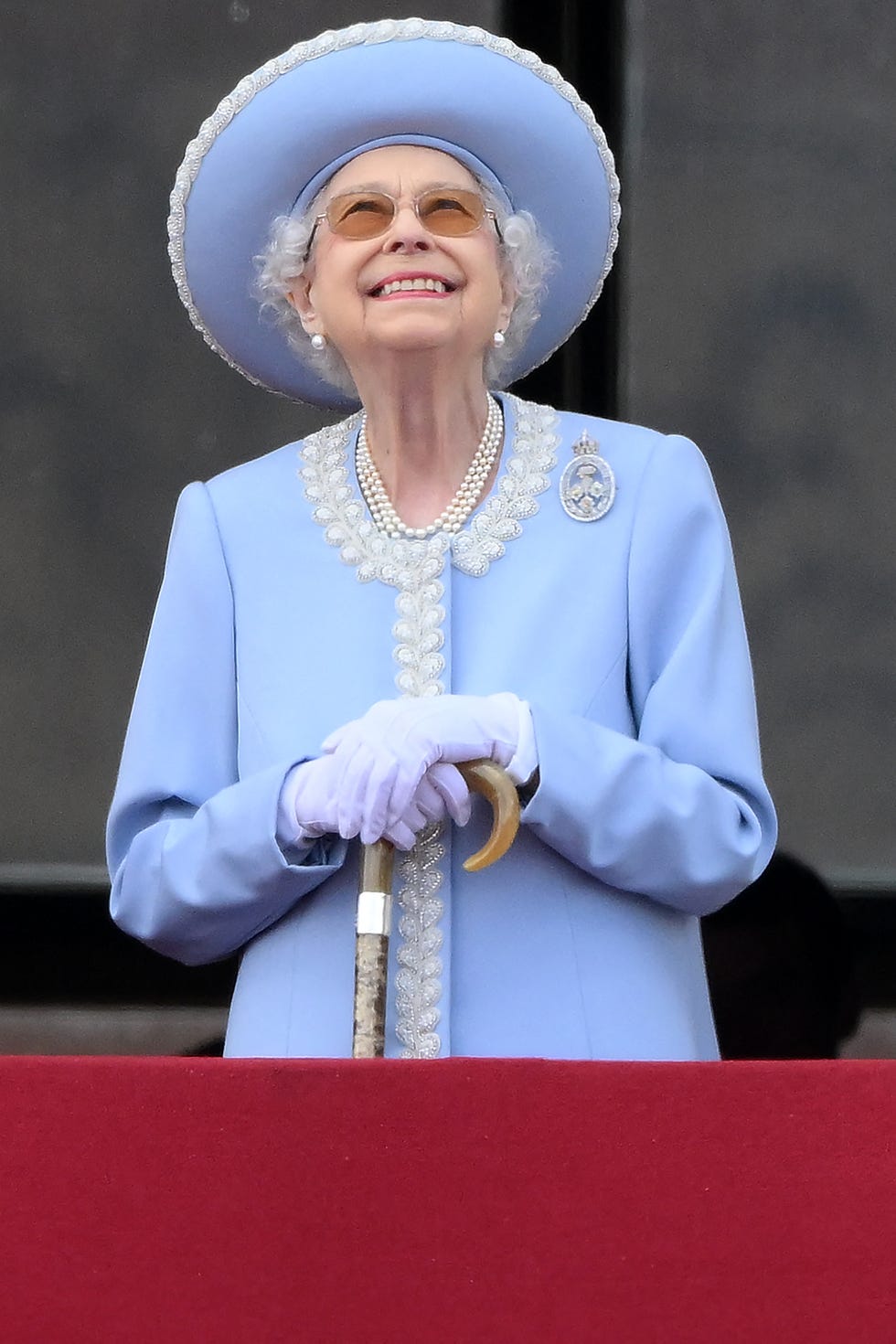 britains queen elizabeth ii stands to watch a special flypast from buckingham palace balcony following the queens birthday parade, the trooping the colour, as part of queen elizabeth iis platinum jubilee celebrations, in london on june 2, 2022   huge crowds converged on central london in bright sunshine on thursday for the start of four days of public events to mark queen elizabeth iis historic platinum jubilee, in what could be the last major public event of her long reign photo by daniel leal  afp photo by daniel lealafp via getty images