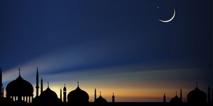 when is eid al adha silhouette dome mosques at night with crescent moon
