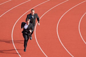 two young business men running on track